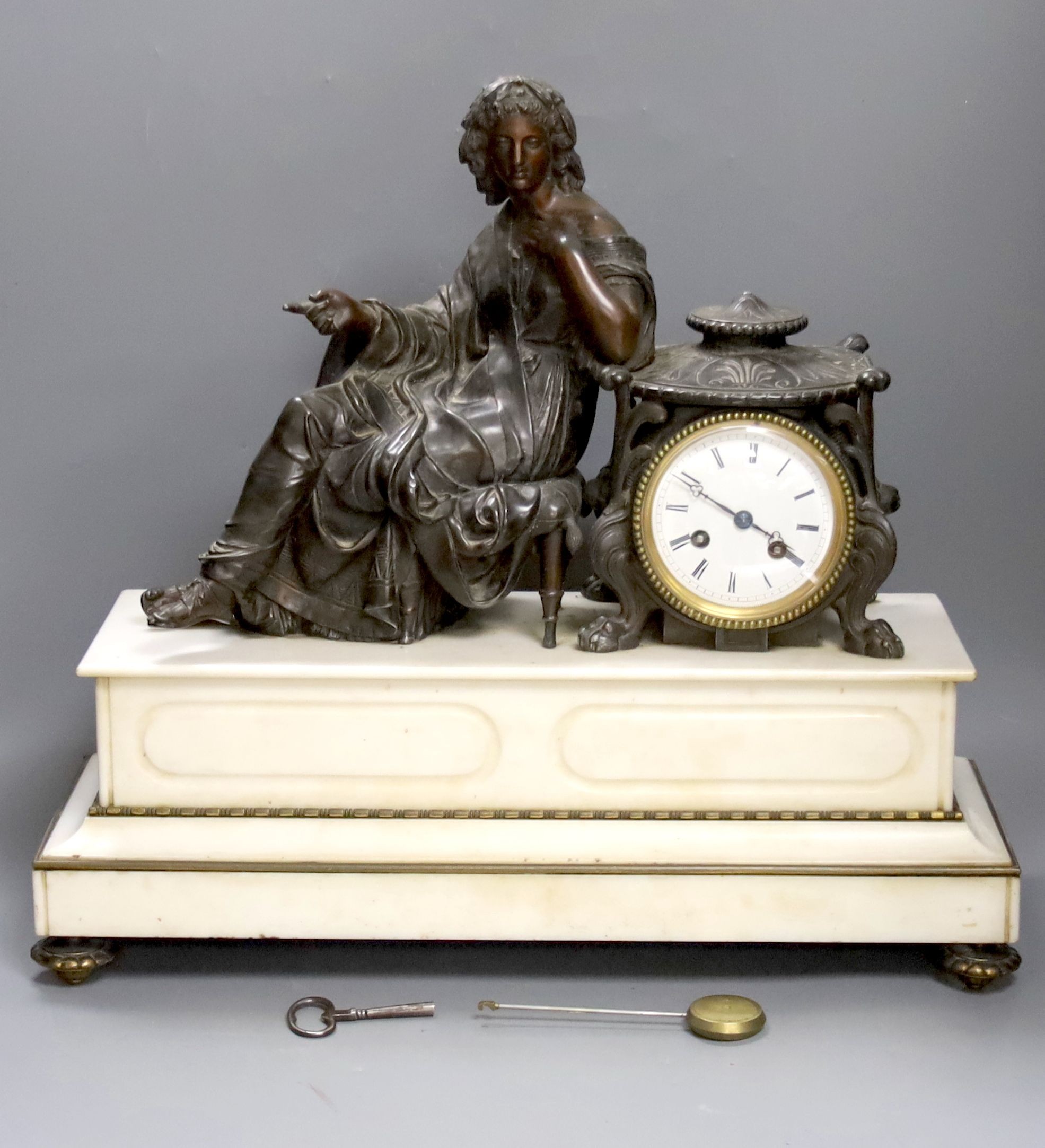 A French marble and bronzed metal figural mantel clock. 49cm